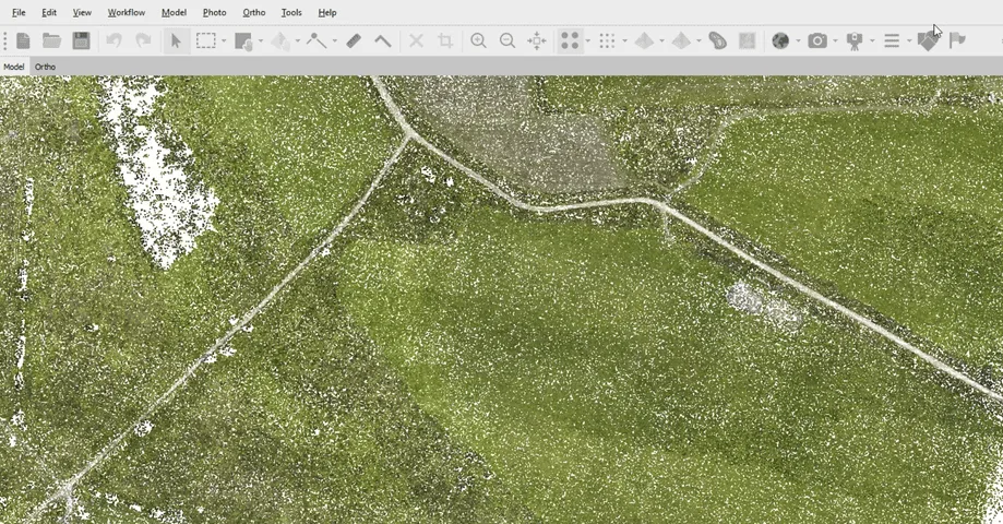 An aerial dataset in the Ortho view: farmland and tracks reconstructed from drone imagery rather than a single object.